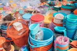 Cheap plastic household items for sale on the market close-up Environment pollution concept