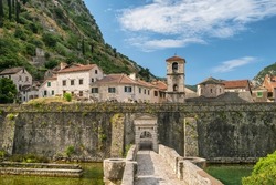 View of northern walls of ancient fortress, River Gate (also North Gate) and church of St. Mary in Old Town of Kotor, UNESCO - World Heritage Site, Montenegro.
