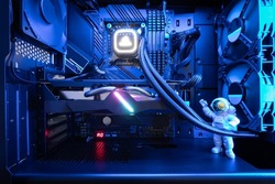 Close-up view of a custom-built gaming PC with liquid CPU Cooler and RGB lighting. Premium gaming setup. Gaming computer. Desktop PC.