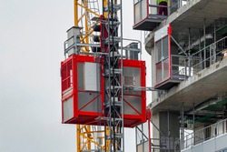 Elevator lifts for workers and material at the construction site.