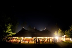 Beautiful wedding tent set up for an outdoor reception. This is a long night exposure, there is blur under the tent showing activity