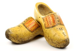 pair of traditional Dutch yellow wooden shoes  on a white background