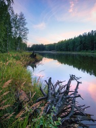 Calm quiet pink sunset on the lake. nature of Russia. Ural. Mirror water.