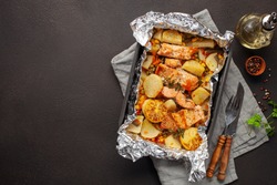 Foil pack dinners. Salmon with vegetables baked in foil. Dietary food. Top view