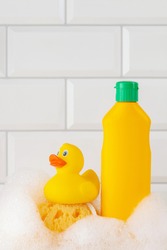 Baby shampoo  on a white  background, rubber yellow ducks, soap foam. Bathroom accessories
