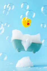 A rubber duck flies into a bath of foam. Spa concept. Global Handwashing Day