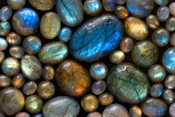 Texture of wet colorful labradorite gem stones.