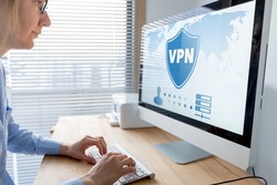 VPN secure connection for telecommuter. Person using Virtual Private Network technology on computer to create encrypted tunnel to remote server on internet to protect data privacy, home office.
