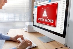 System hacked alert after cyber attack on computer network. Cybersecurity vulnerability on internet, virus, data breach, malicious connection. Employee working in office.