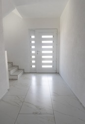White entrance door with marble tiled floor 