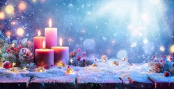 Advent - Four Purple Candles With Christmas Ornament In Shiny Night
