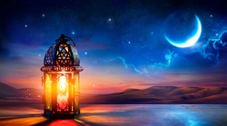 Muslim Holy Month Ramadan Kareem - Ornamental Arabic Lantern With Burning Candle Glowing At Evening