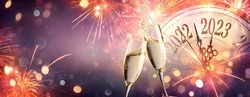 2023 New Year Celebration With Champagne  - Countdown To Midnight - Clock Fireworks And Flutes On Abstract Defocused Background