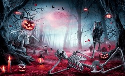 Halloween - Skeletons In Spooky Forest At Moonlight - Jack O’ Lantern  In Cemetery At Twilight