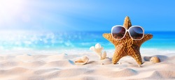 Starfish With Sunglasses In The Sunny Beach
