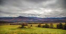 An HDR image of a valley and fall colors and overcast cloudy sky in the mountains of Tennessee.
