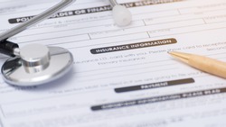 Close-up of health insurance form,Stethoscope and pen on a health insurance application medical information