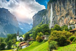 Amazing touristic alpine village with famous church and Staubbach waterfall, Lauterbrunnen, Switzerland, Europe