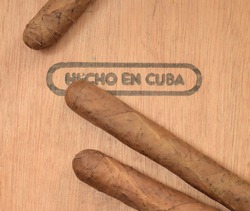 Cuban handmade tobacco cigars on wooden cedar box with text on spanish 