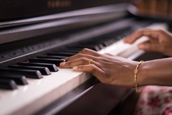 Dark Skin Female Hands Playing Piano