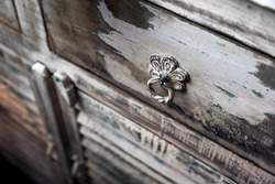 the handle of an old rustic cupboard, a drawer