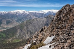 Scenic view of Chimgan mountain range in spring, amazing nature landscape with rocks, snowy peaks, valley and blue sky, outdoor travel background, Uzbekistan, near the Tashkent