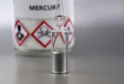 Mercury chemical element stock images. Laboratory accessories images. Mercury in a sealed ampoule stock photo. Laboratory equipment on a silver background. Hg, toxic chemical element stock images