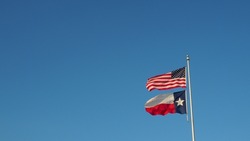 USA and Texas flags waving 