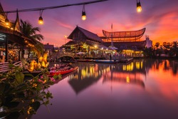 Sunset at famous Pattaya Floating Market which has traditional rowing boats. Villagers sell traditional foods and souvenirs.