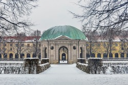 Munich, Germany, winter view with snow of the Hofgarten round pavilion in the baroque garden