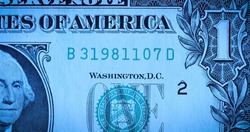 Front side of one dollar paper bill with portrait of first President George Washington. American dollars with banknote number in macro shot. American currency, greenback, cash. Money background.