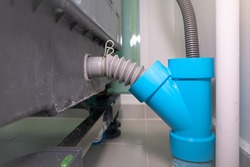 Drain pipe or tube consist of y shape of pvc plastic pipe fitting and plastic corrugated flexible hose. To connect water drainage system with sink, basin, washing machine and dishwasher in home.