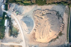 Pile of sand and rock or gravel in concrete plant in aerial view or top view. Heap of aggregate or material from nature, mine or quarry for mix with cement, concrete for industry construction work.