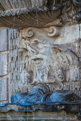 Ancient sculpture of funny, tricky and joyful dickens at fountains in historical downtown of Dresden, Germany, details, closeup. Concept of art and historical heritage