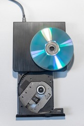 Compact stylish video player or recorder for CD and DVD disks at solid grey background