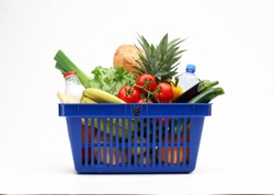Shopping basket full of vegetables, fruits, bread and milk products on white background.