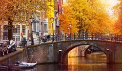 Channel in Amsterdam Netherlands houses river Amstel landmark old european city autumn landscape.