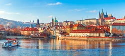 Old town of Prague. Czech Republic over river Vltava with Saint Vitus cathedral on skyline. Bright sunny day blue sky. Praha panorama landscape view.