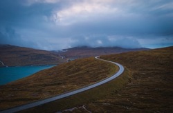 Kvivik Streymoy Faroe Islands, Denmark, Europe november 2021: curved road at sunset time.