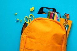 Back to school concept. Backpack with school supplies. Top view. Copy space