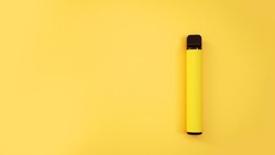 Yellow disposable electronic cigarette on bright yellow background