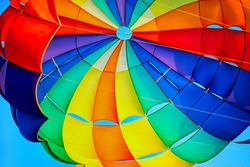 Canopy of a multicolor parachute in air.