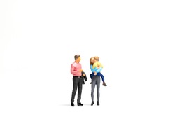 Miniature people Happy family standing on white background and copy space for text
