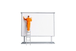 Miniature people Painter at The front of a whiteboard isolated on white background  with clipping path