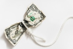 White rope tangled around a crumpled one dollar bill. Concept of money fraud, debt or credit payments.