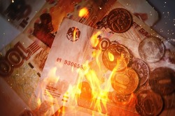 Background of burning russian rubles in fire flames