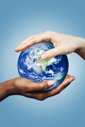 African and Caucasian female hands holding earth globe. Different concept such as ecology, international friendship and equality. Elements of this image furnished by NASA.