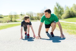 father with son sport running together outside