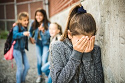A sad girl intimidation moment on the elementary Age Bullying in Schoolyard