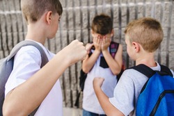 The Cruel teenagers punching younger boy, physical intimidation, school bullying